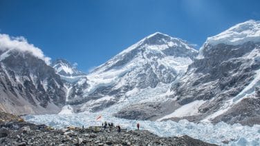 Group of trekkers near Khumbu Icefall, admiring the stunning view of the Everest range.