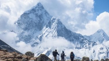 Stunning image of Mount Everest Base Camp with colorful prayer flags and snowy terrain
