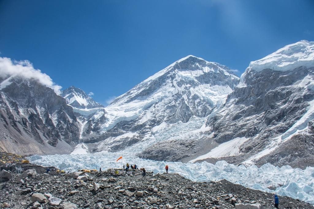 Exotic Mountains: Stunning photo of Everest Base Camp, featuring majestic peaks, swirling clouds, and a lone tent