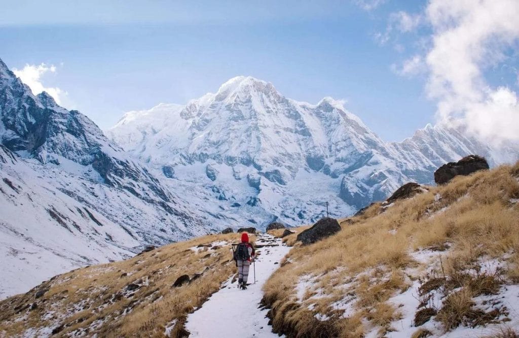 Hyperrealistic image of a trekker pondering a daunting pass in Nepal's Annapurna Circuit at dawn.