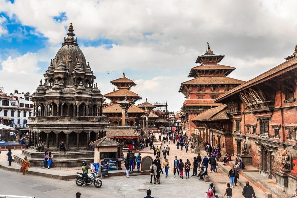 Visit Nepal vibrant Kathmandu at dawn, with bustling streets, intricate architecture, and Himalayan backdrop.