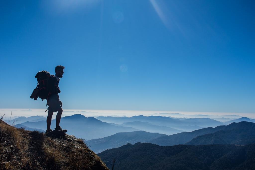 Hikers at Himalaya base with Everest and Nepalese cultural highlights in a vibrant photo.