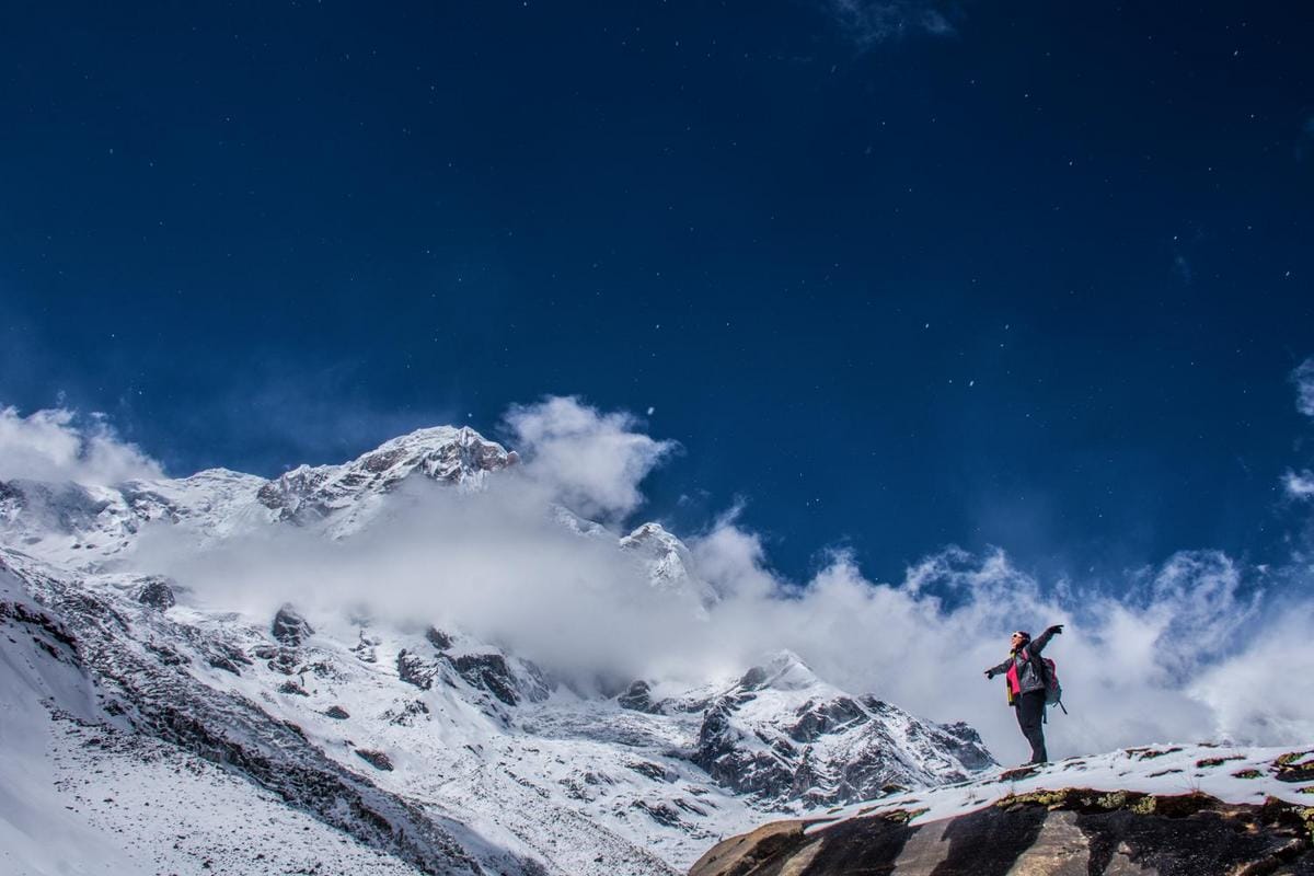 Alt text: Hyperrealistic photo of trekkers with map in Nepal's Himalayas at sunrise, capturing serenity and grandeur.
