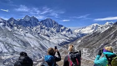 Revamped Everest Base Camp in 2025: trekkers amidst advanced eco-friendly tech at dawn.