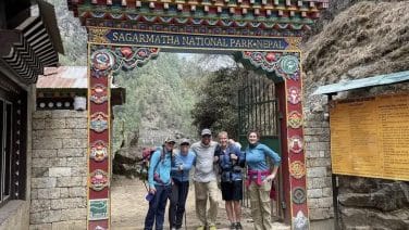 Trekkers ascend toward Everest Base Camp against a backdrop of imposing Himalayan peaks.