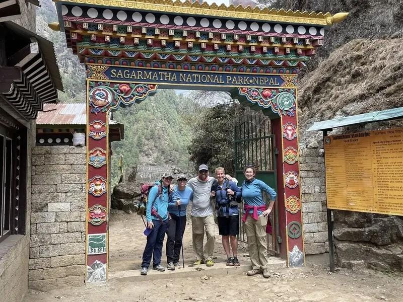 Trekkers ascend toward Everest Base Camp against a backdrop of imposing Himalayan peaks.